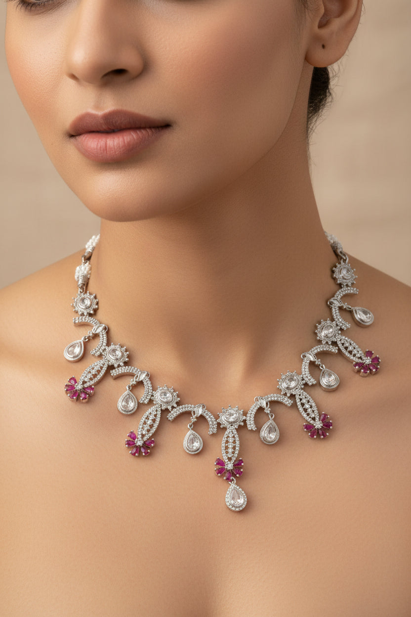 Silver necklace with red stones on a white background