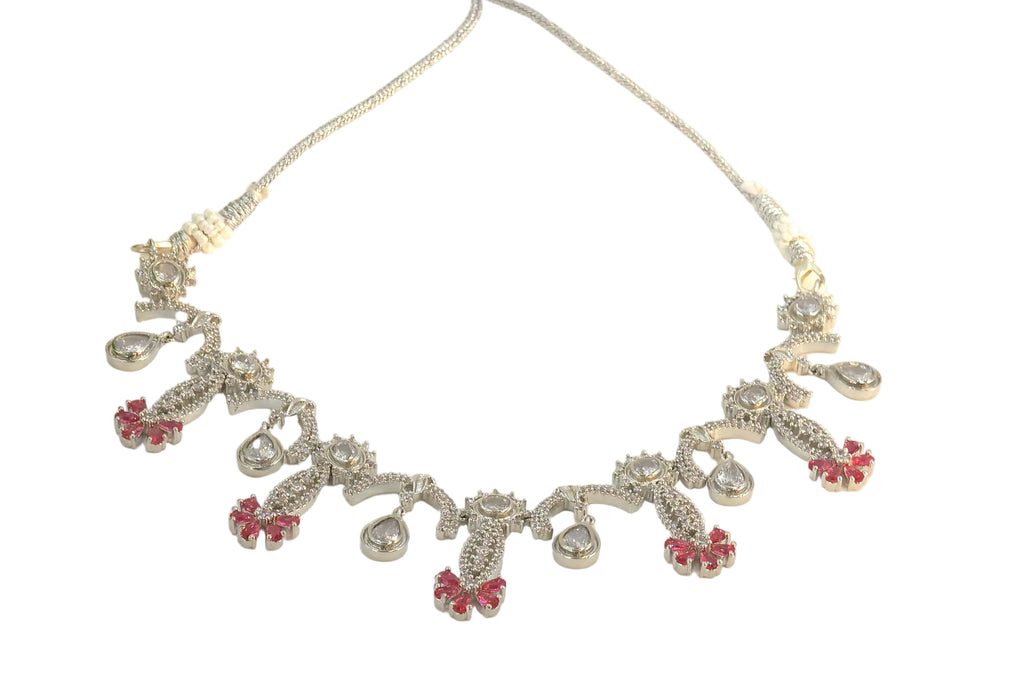 Silver necklace with red accents on a white background