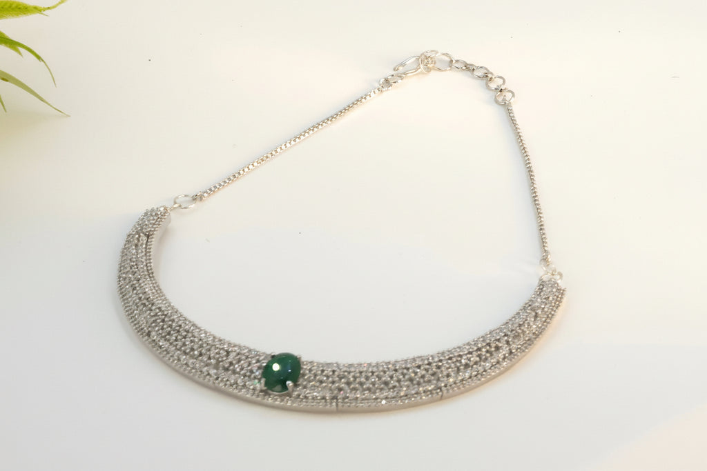 White diamond necklace with green gemstone